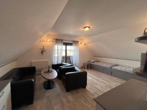 a living room with two couches and a table at Penzion Villa Alena in Velké Bílovice