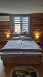 a large bed in a bedroom with a window at Apartman Mila 2 in Jajce