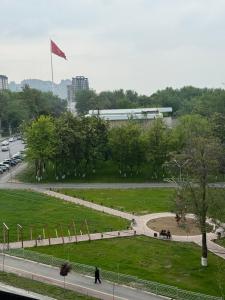a park with a red flag in the middle at ЖК Сити Парк in Osh