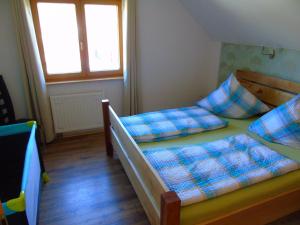 a bedroom with two beds and two windows at Ferienwohnung Csilla in Unterweid