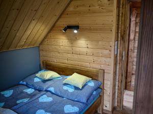 a bedroom with two beds in a wooden cabin at Domki Markowa Dolina in Rymanów
