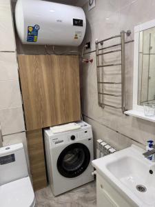 a washing machine in a bathroom with a sink at ЖК Сити Парк in Osh
