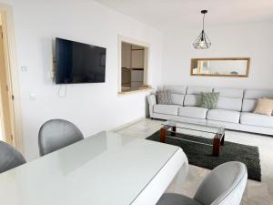 a white living room with a white couch and a table at Balcon Del Mar Primera Linea de Playa in La Cala de Mijas +38 photos