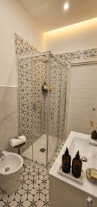 a bathroom with a shower and a toilet and a sink at Habibi Gerard in Torre del Greco