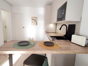 a kitchen with a table with two plates on it at Luz de Belén in Jaén
