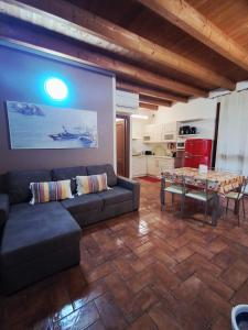 a living room with a couch and a table at Respiro di Lago - Pool Friend in Paratico