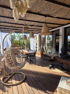 a wooden deck with a chair and a table at chambres d hôtes villa del sole in Puget-sur-Argens