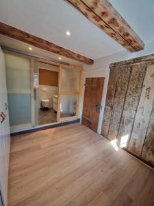 an empty room with wood floors and a bathroom at Faktorei 312 in Eibau