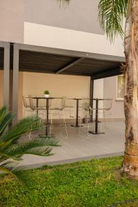 a patio with a table and chairs under a building at Building Hotel in Teverola