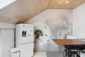 a kitchen with a refrigerator and a wall with a flower mural at Fewo Kurt in Villingen-Schweninngen in Villingen-Schwenningen