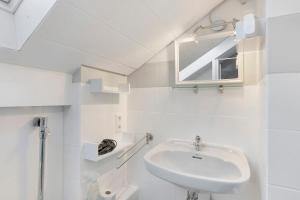 a white bathroom with a sink and a mirror at Fewo Kurt in Villingen-Schweninngen in Villingen-Schwenningen +9 photos