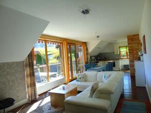 a living room with a couch and a table at Ferienwohnung Csilla in Unterweid