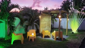a group of chairs in a yard at night at Paradise House in Saint-François