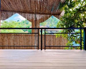 a wooden deck with a view of trees and mountains at Phi Phi Vista Nest Resort in Phi Phi Islands