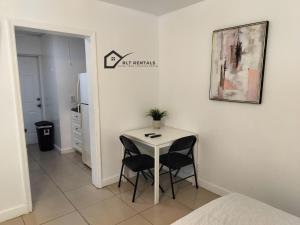 a small white table with two chairs in a room at Comfortable Large Studio-J in Hollywood