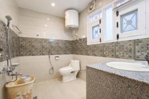 a bathroom with a toilet and a sink at De Elaaf The Luxury Stay in Srinagar +26 photos