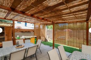 a patio with a table and chairs and a view of a yard at Charming LUCCA in Lucca +60 photos
