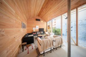 a living room with wooden walls and a wooden ceiling at Cabane Cala - Coeur d'Arcachon in Arcachon