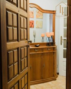 an open door to a bathroom with two lamps on a vanity at Casa da Amorosa com Vista Mar by Lethes Legacy in Abelheira +68 photos