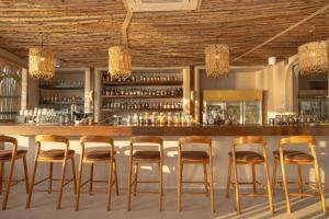 a bar with wooden stools in a restaurant at The Beachfront Hostel in Chaweng