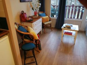 a room with chairs and a dresser and a window at Studio in Argentat