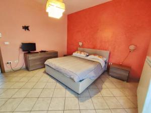 a bedroom with a bed and a tv in it at Terrazza Lumière in Alezio