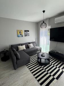 a living room with a couch and a table at Misa Home in Nyíregyháza