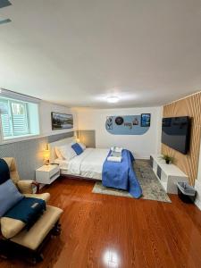a bedroom with a bed and a couch and a tv at Spacious room near subway & shops in Toronto