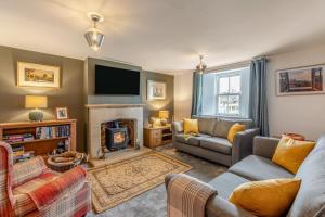 a living room with a couch and a fireplace at 2 Bed in Caldbeck oc-b38644 in Caldbeck