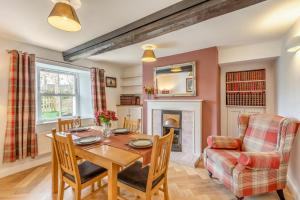 a dining room with a table and a fireplace at 2 Bed in Caldbeck oc-b38644 in Caldbeck