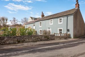 a white house on the side of a street at 2 Bed in Caldbeck oc-b38644 in Caldbeck