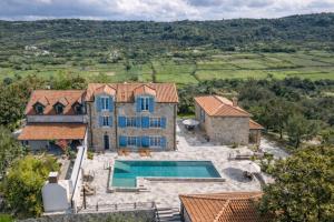 an aerial view of a house with a swimming pool at Deluxe Nature Resort Galovi Dvori in Rab