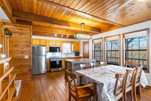 a kitchen and dining room with a table and chairs at Making Memories in Blairsville