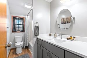 a bathroom with a sink and a toilet and a mirror at Making Memories in Blairsville +33 photos