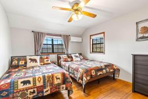 a bedroom with two beds and a ceiling fan at Making Memories in Blairsville