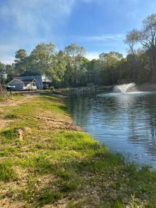 a campsite with a lake and a trailer at Country Hideaway For A True Getaway in Montgomery