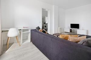 a living room with a couch and a table at Carmen's Place in Ponta Garça