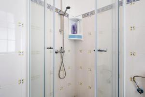 a bathroom with a shower with glass doors at Carmen's Place in Ponta Garça +13 photos
