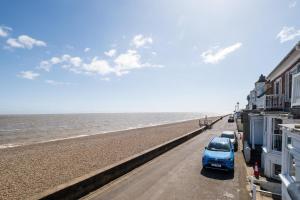 a row of cars parked on the beach at Magenta - A stunning Seafront house with lovely and uninterrupted Beach Views - Aldeburgh Coastal Cottages in Aldeburgh