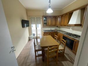 a kitchen with a table and chairs and a stove at Il fico in Bovalino Marina