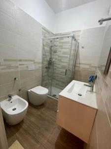 a bathroom with a toilet and a sink and a shower at Il fico in Bovalino Marina
