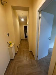 an empty hallway with a door to a room with wood floors at Il fico in Bovalino Marina