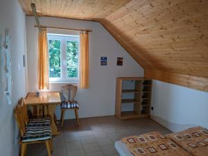 a room with a desk and a bed and a window at Na Černém potoce in Rokytnice nad Jizerou