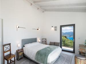 a bedroom with a large bed and a large window at Grey Sea View Estate - Luxury Villas with Private Pool & Plunge Pool in Katouna +176 photos