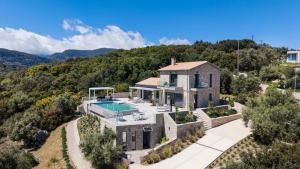 an aerial view of a house with a swimming pool at Grey Sea View Estate - Luxury Villas with Private Pool & Plunge Pool in Katouna