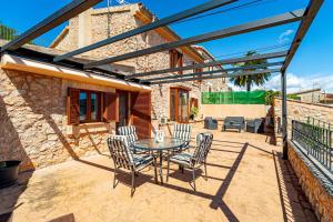 a patio with a table and chairs on it at Villa Sa Costa - Families or Couples Only in Calvià