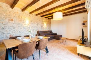 a living room with a wooden table and a couch at Villa Sa Costa - Families or Couples Only in Calvià +22 photos