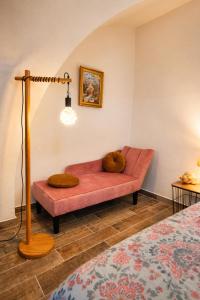 a living room with a couch in a room at L'écrin du Pont du Gard - Parking gratuit - Charme & Pierres in Remoulins