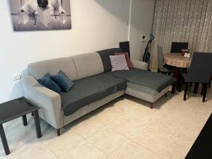 a living room with a couch and a table at Lovely Apt Close to Beach in Nahariyya