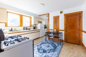 a kitchen with a stove and a table in it at 152 Quite & Bright & Spacious Apt in Brighton in Boston